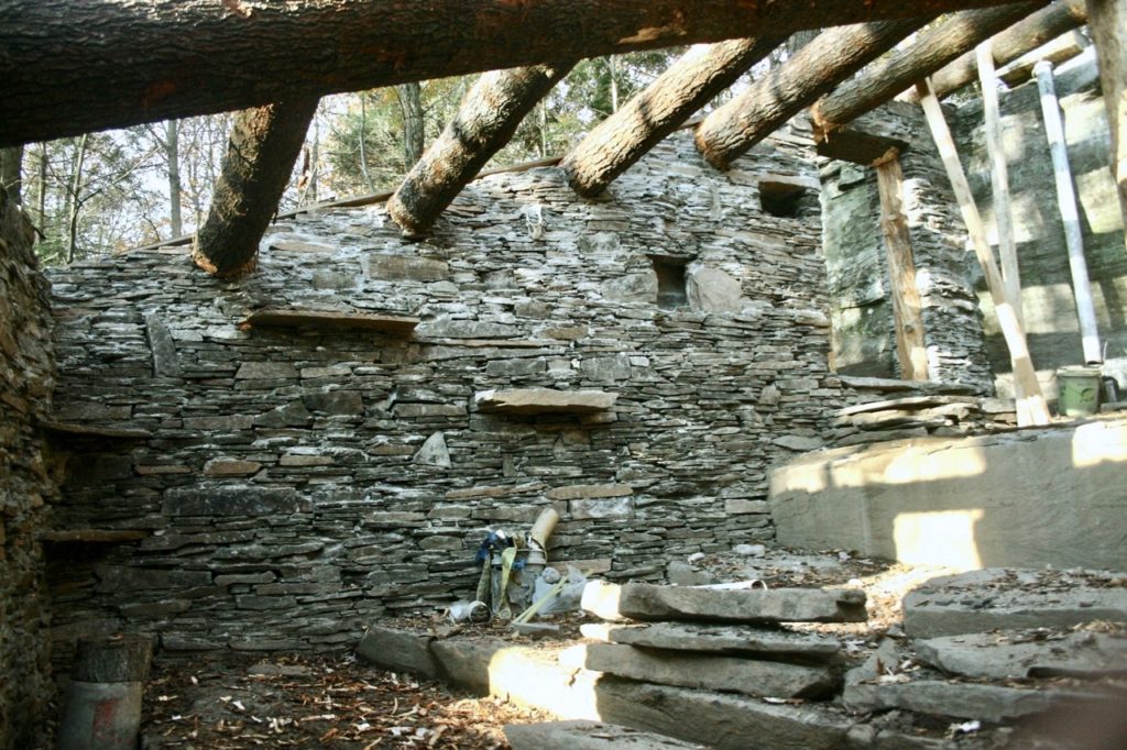 Walls almost done, still needs a roof. Note the overbuilt rafters that will support the heavy load of dirt.