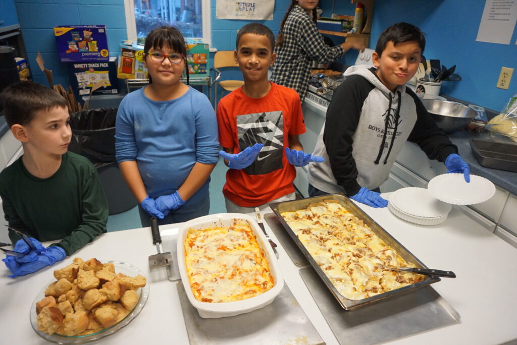 Our young farmer chefs serving up some lasagna with homemade pasta from our homegrown wheat and homemade tomato sauce from our homegrown tomatoes.